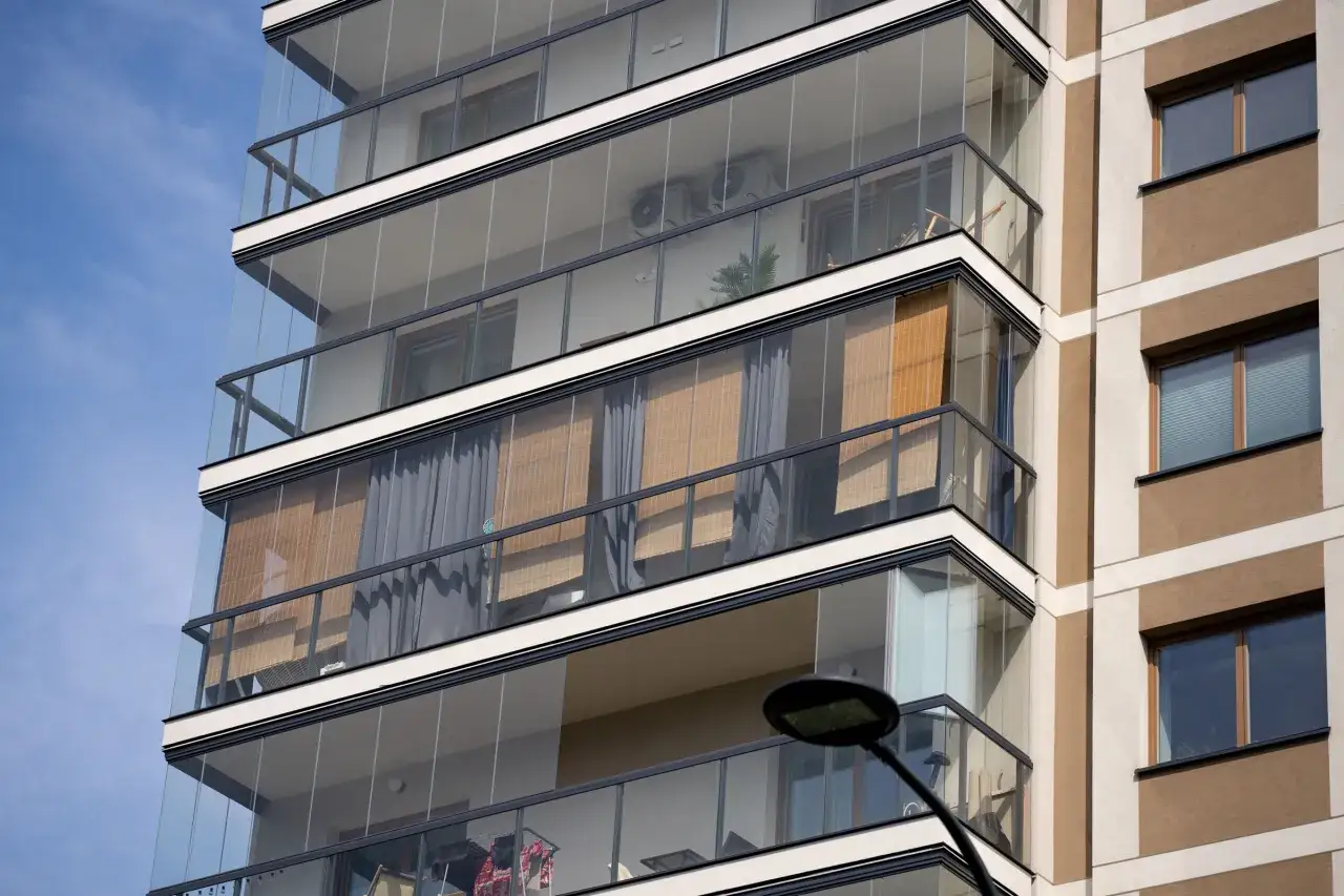 Nowoczesne balkony w bloku, zabudowane szkłem, tworzą dodatkową przestrzeń.